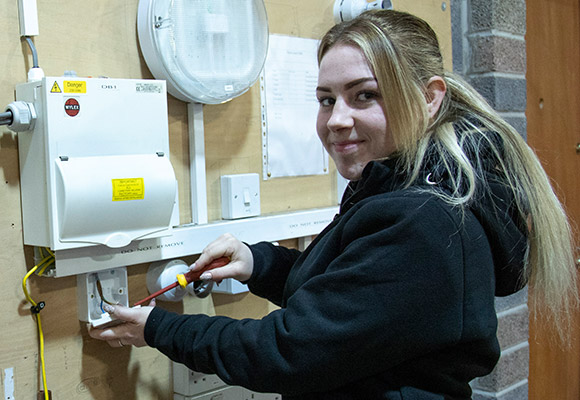 Charlie smiling while wiring a socket