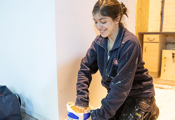 Painting and Decoration Apprentice stirring paint