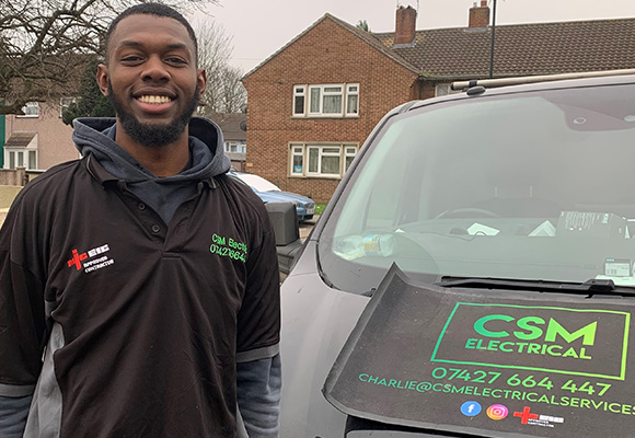 Marley stood next to works van smiling.